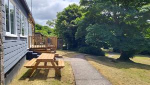 a wooden picnic table on the side of a house at 15 The Park in Bude