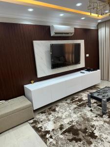 a living room with a large tv on a wall at الخمايل الشيخ زايد in Kafr Abū ʼumaydah +7 photos