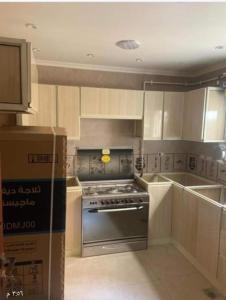 a kitchen with a stove and a box in it at الخمايل الشيخ زايد in Kafr Abū ʼumaydah