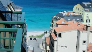 a view of the ocean from a city street at Öspede Lara Malpica de Bergantiños-Costa da Morte in Malpica