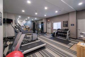 a fitness room with treadmills and a gym at Candlewood Suites Deer Park by IHG in Deer Park
