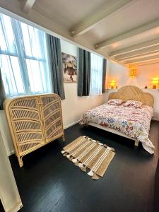 a bedroom with a bed and a large window at Le Loft Rouen Centre in Rouen