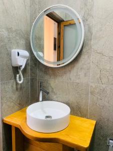 a bathroom with a white sink and a mirror at Vila Franko in Berat +37 photos
