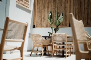 a table with chairs and a plant in a room at Kalani Residence in Keramoti