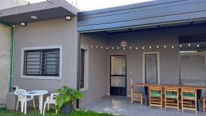 a house with a patio with a table and chairs at Casa Rafael in La Plata