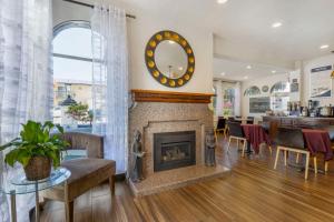 a living room with a fireplace and a clock on the wall at Best Western San Marcos Inn in Morro Bay