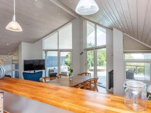 a kitchen and dining room with a table and chairs at 5 star holiday home in Hadsund-By Traum in Hadsund