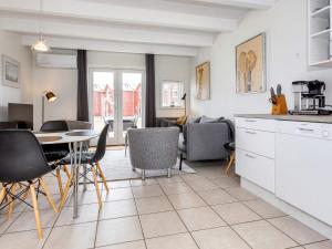 a kitchen and dining room with a table and chairs at 6 person holiday home in Hadsund-By Traum in Hadsund +35 photos