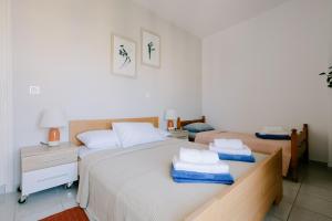a bedroom with two beds with towels on them at Stadium Apt in Kos