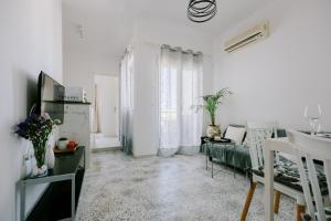 a living room with a couch and a table at Stadium Apt in Kos +20 photos