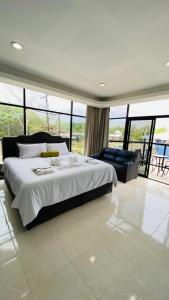 a large bedroom with a large bed and a couch at The Alexandria Marquis Hotel and Resort in San Ignacio