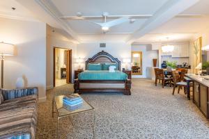 a bedroom with a bed and a living room at Pacific Terrace Hotel in San Diego