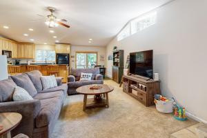 a living room with a couch and a tv at Fire Pit, Near Lake: 'Evergreen Escape' in Arnold in Arnold