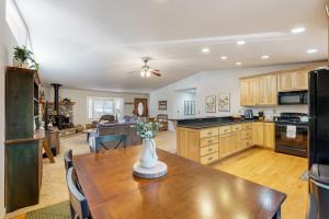 a kitchen and living room with a wooden table at Fire Pit, Near Lake: 'Evergreen Escape' in Arnold in Arnold