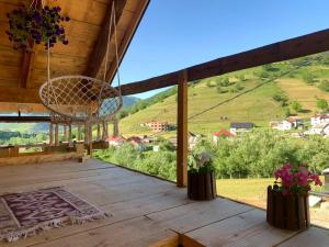 a view from the porch of a wooden house with a basket at CAMP Odmaraliste PURISIC in Plav