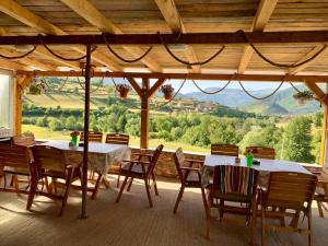 a dining room with tables and chairs and a large window at CAMP Odmaraliste PURISIC in Plav
