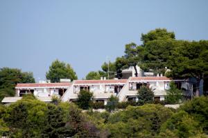 un edificio in cima a una collina con alberi di Cala D'Aspide a Santa Caterina di Nardò