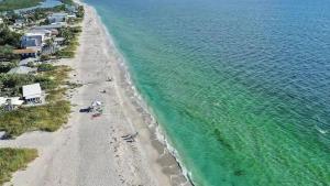 an aerial view of a beach and the ocean at Sand Dollar Siesta-walk to beach less than 1 min! in Englewood