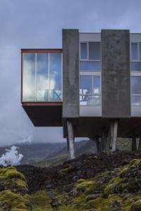 a building on top of a hill with glass at ION Adventure Hotel, Nesjavellir, a Member of Design Hotels in Nesjavellir