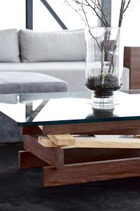 a glass vase on a wooden table in a living room at ION Adventure Hotel, Nesjavellir, a Member of Design Hotels in Nesjavellir