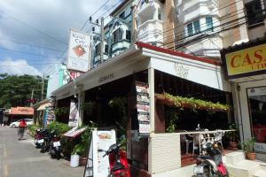 a store with motorcycles parked outside of it on a street at Karon Cafe Inn in Karon Beach