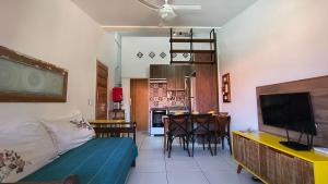 a living room with a couch and a dining room at Condomínio Reserva dos Corais in Cabo de Santo Agostinho