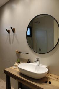 a bathroom with a white sink and a mirror at Hotel Del Llano in Realicó