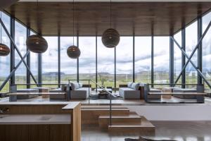 a living room with a lot of windows at ION Adventure Hotel, Nesjavellir, a Member of Design Hotels in Nesjavellir