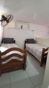 a bedroom with two beds in a room at Condomínio Reserva dos Corais in Cabo de Santo Agostinho +25 photos