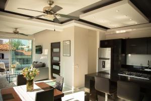a kitchen with a ceiling fan and a dining room at Makari Vallarta in Puerto Vallarta