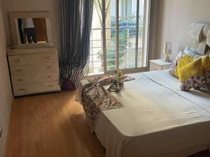 a bedroom with a bed with a dresser and a window at Prestigia luxury home in Fez