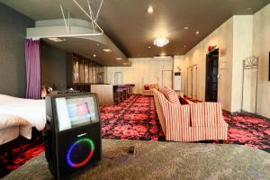 a hotel room with a bed and a video game at Rose hakodate in Hakodate