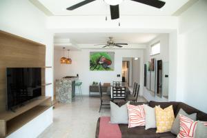 a living room with a couch and a dining room at Makari Vallarta in Puerto Vallarta