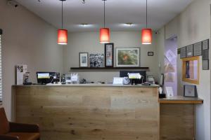 a bar in a restaurant with two pendant lights at Country Inn & Suites by Radisson, Sparta, WI in Sparta
