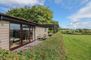 a house with sliding glass doors and a patio at Upham View in Exeter