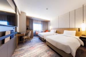 Postel nebo postele na pokoji v ubytování Hotel Metropolitan Edmont Tokyo