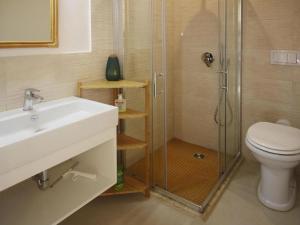 a bathroom with a shower and a sink and a toilet at Holiday Home Magazzini with Sea View in Magazzini