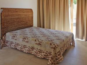 a bed in a room with a blanket on it at Holiday Home Magazzini with Sea View in Magazzini
