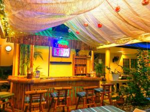 a bar with a bunch of stools in a restaurant at Villa Viva Belgica in Davao City