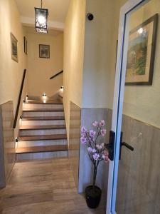 a hallway with stairs with a vase with flowers in it at Nelly's Apartment in Buenos Aires