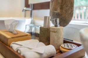 a bathroom counter with towels and a soap dispenser at VillaJewel Bali in Dalung +27 photos