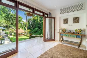 an open living room with a large sliding glass door at VillaJewel Bali in Dalung