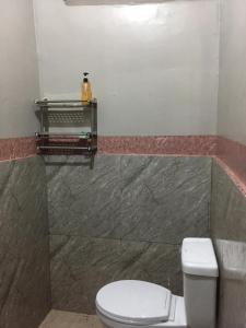 エルニドにあるDishan Homestay El Nidoのバスルーム(トイレ付)、壁に棚が備わります。