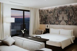 ein Hotelzimmer mit 2 Betten, einem Tisch und einem Sofa in der Unterkunft December Hotel in Nha Trang + 58 Fotos