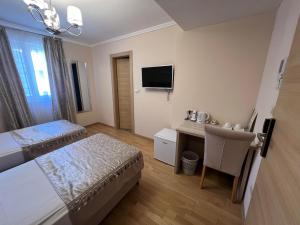 Postelja oz. postelje v sobi nastanitve Benjamin Hotel
