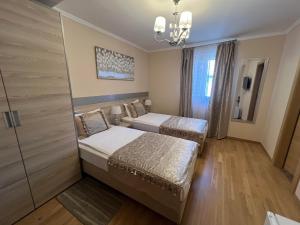 Postelja oz. postelje v sobi nastanitve Benjamin Hotel