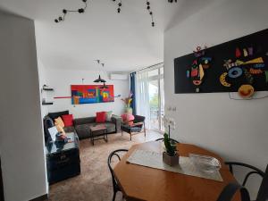 a living room with a table and a couch at Art Gallery House with a small relaxing pool in Crikvenica