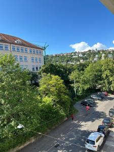 a city street with cars parked in a parking lot at Renovated Flat - Prime Location Near Marienplatz in Stuttgart