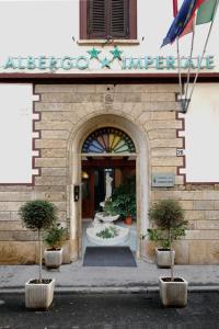 an entrance to a building with potted plants in front at Albergo Imperiale in Livorno