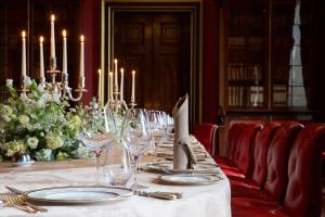 a long table with wine glasses and candles on it at Wynyard Hall Hotel & Spa in Billingham